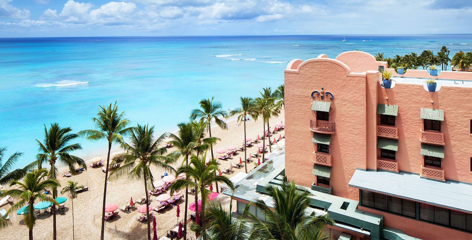 a building with palm trees and a beach