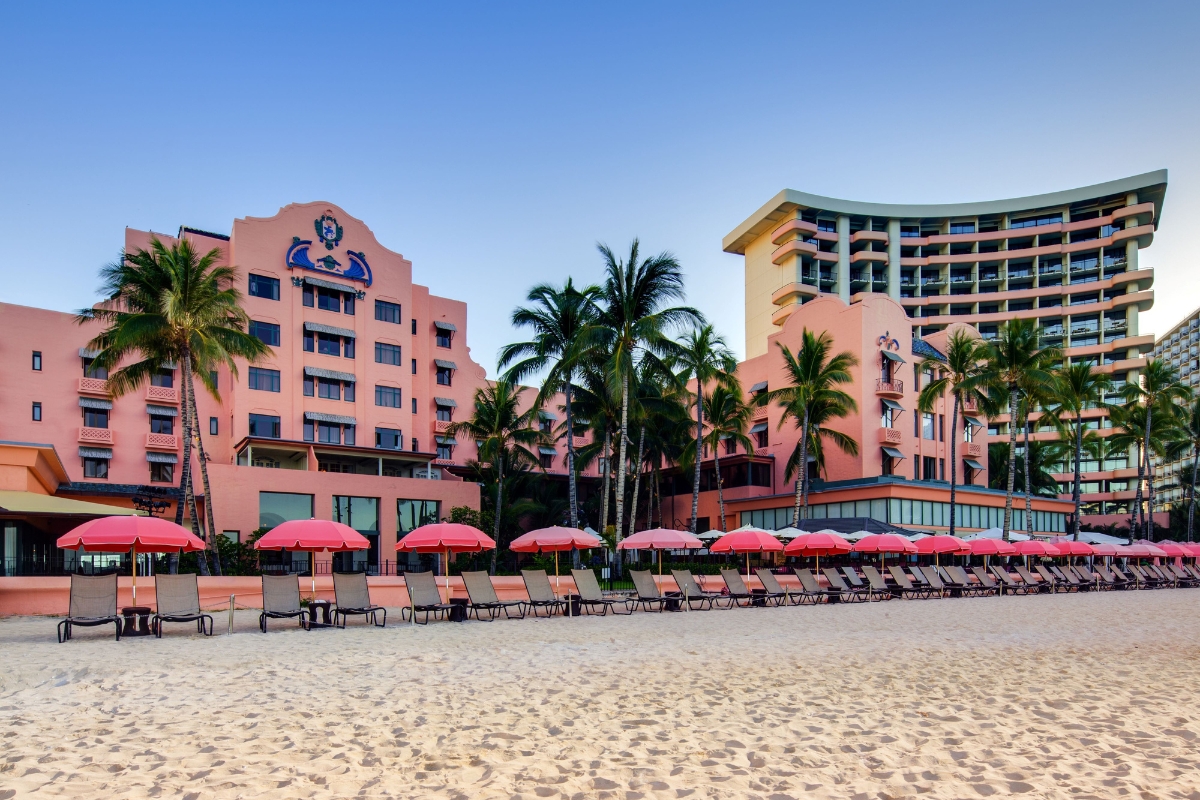 a beach with palm trees and chairs and umbrellas