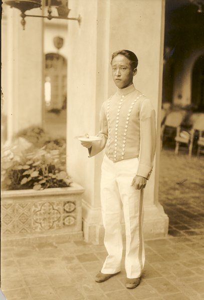 a man in uniform holding a bowl