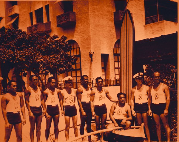 a group of men in swimsuits posing for a photo