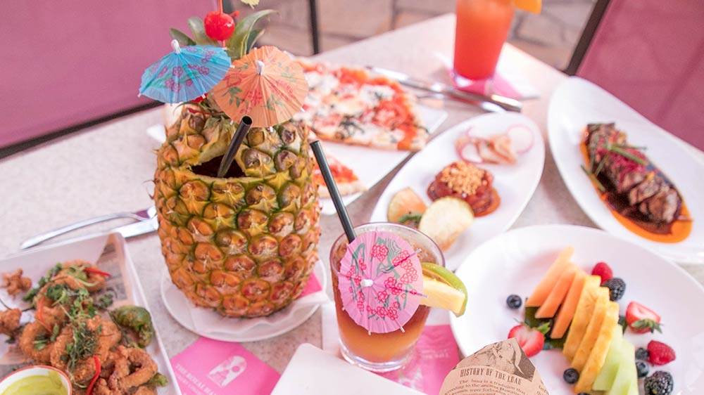 a pineapple with umbrellas on top of a table