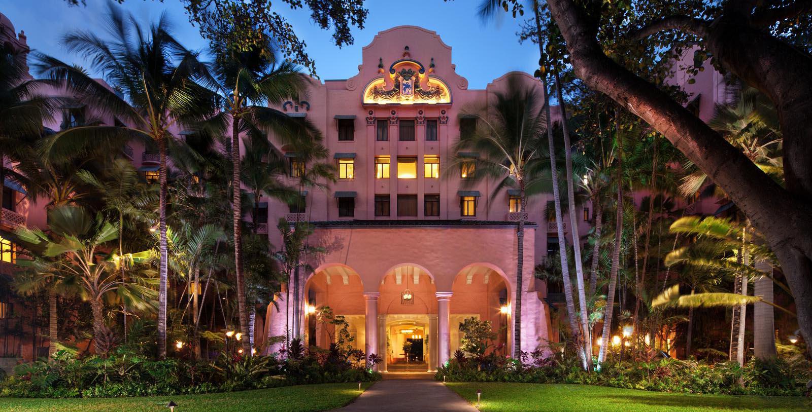 a building with palm trees and a walkway