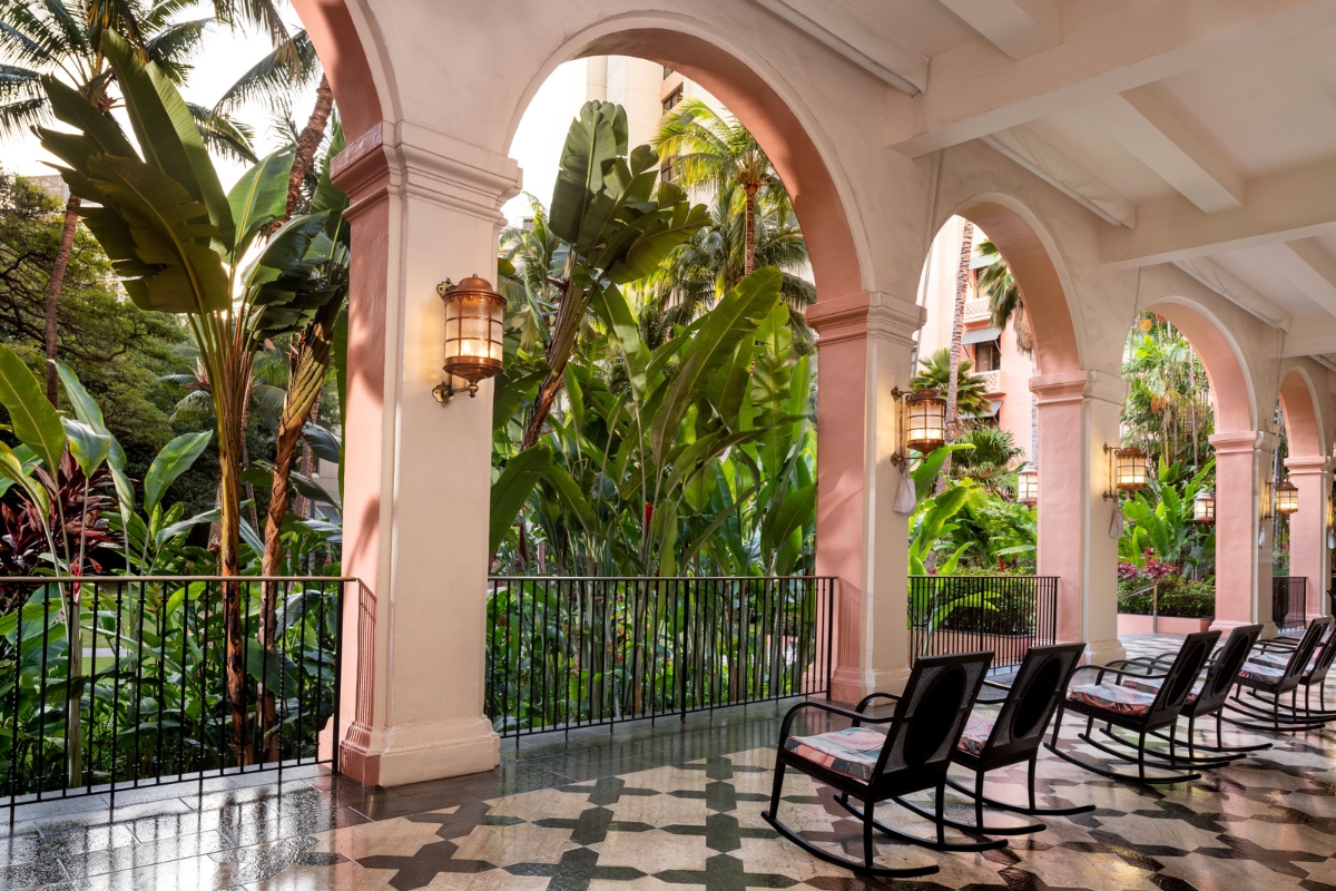 a patio with chairs and a railing