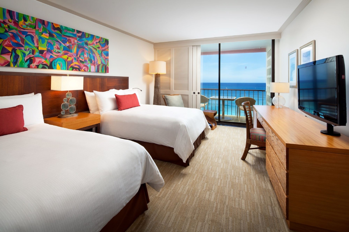 a hotel room with two beds and a desk