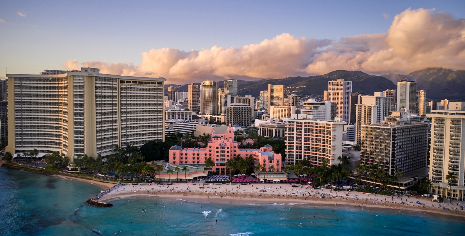 a beach with buildings and a body of water