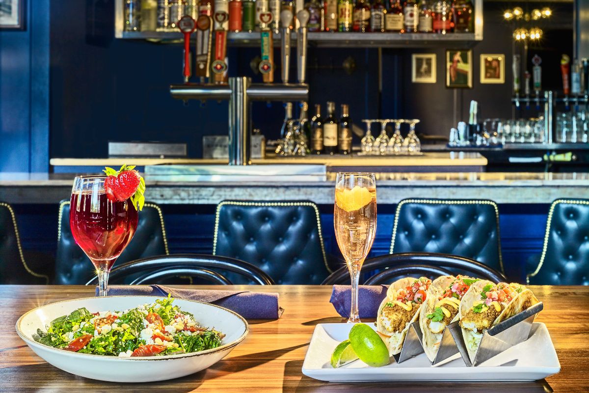 a table with plates of food and drinks