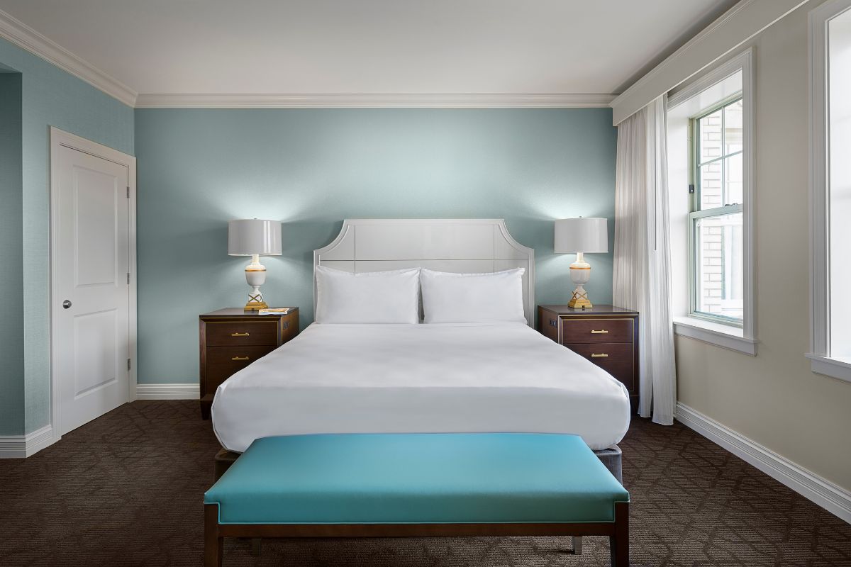 a bedroom with a bed and a bench