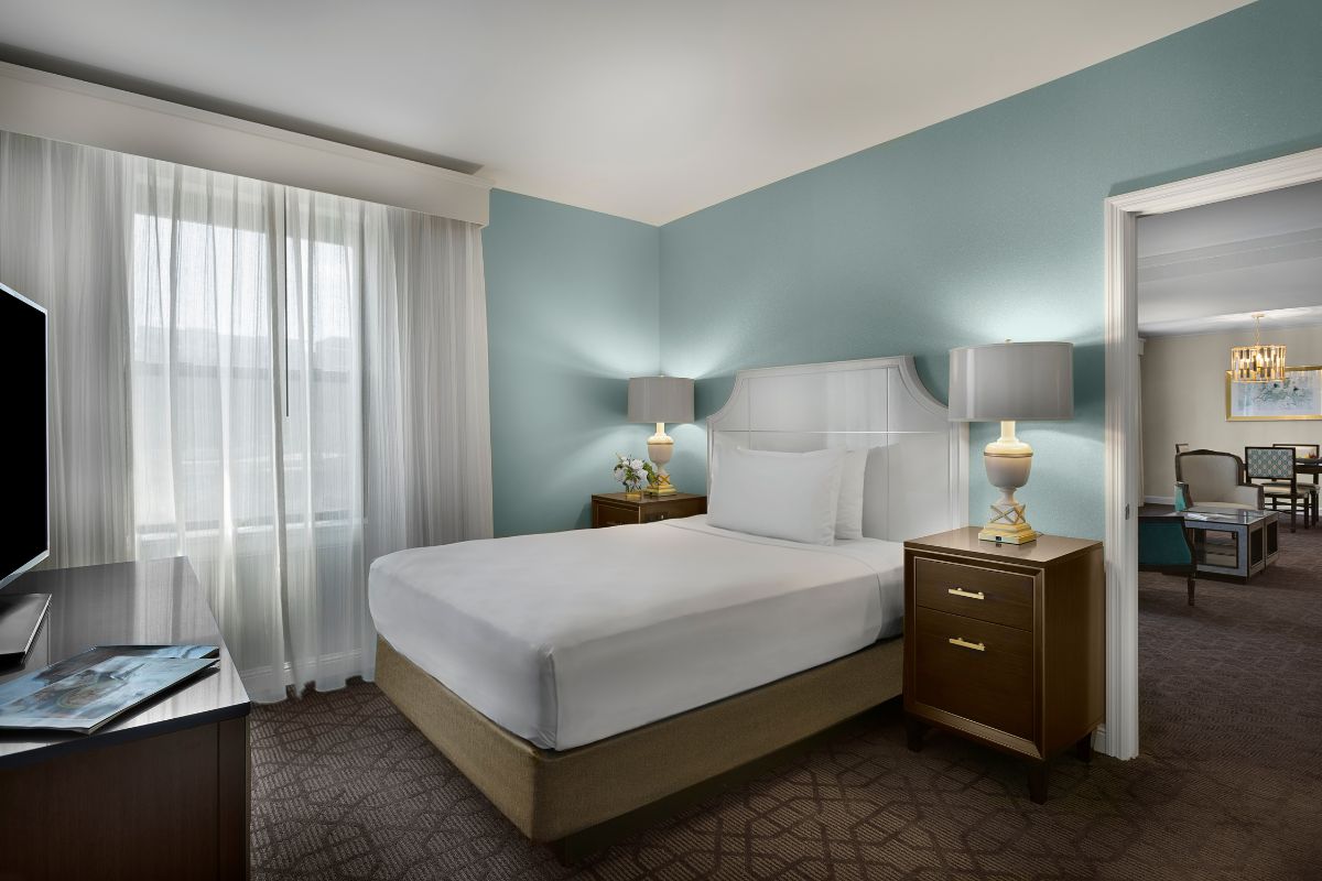 a bedroom with a bed and two lamps