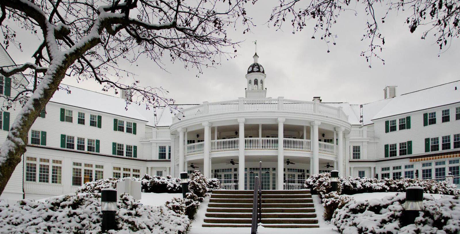 a white building with a round roof and a round balcony