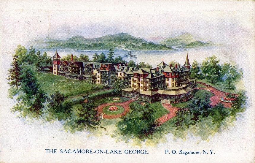 a large building with a lawn and trees