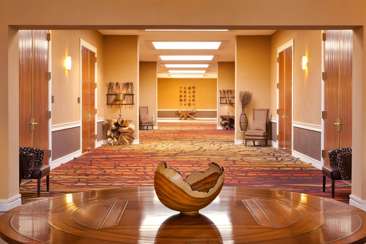 a room with a large round table and a vase on it