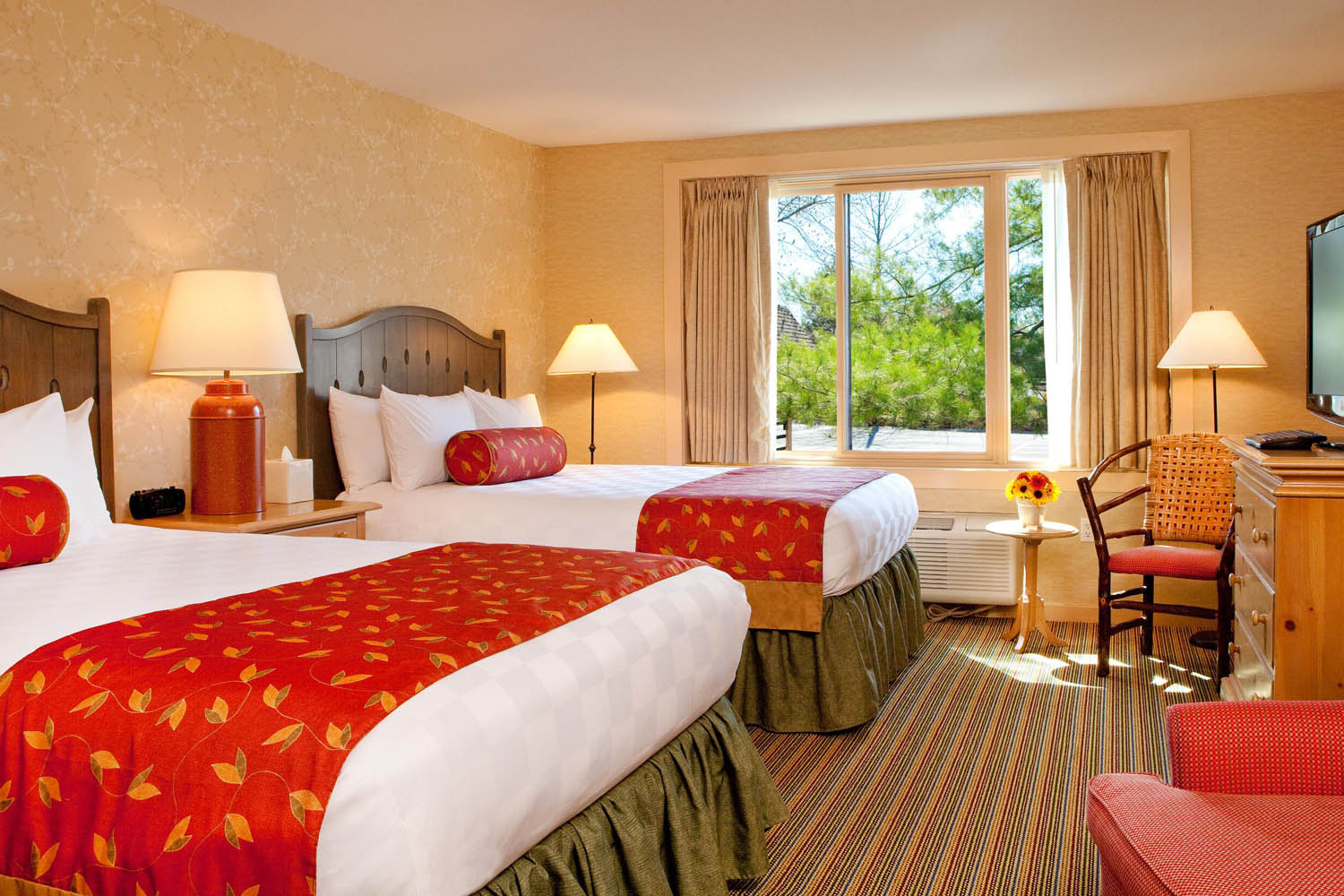 a room with two beds and a window