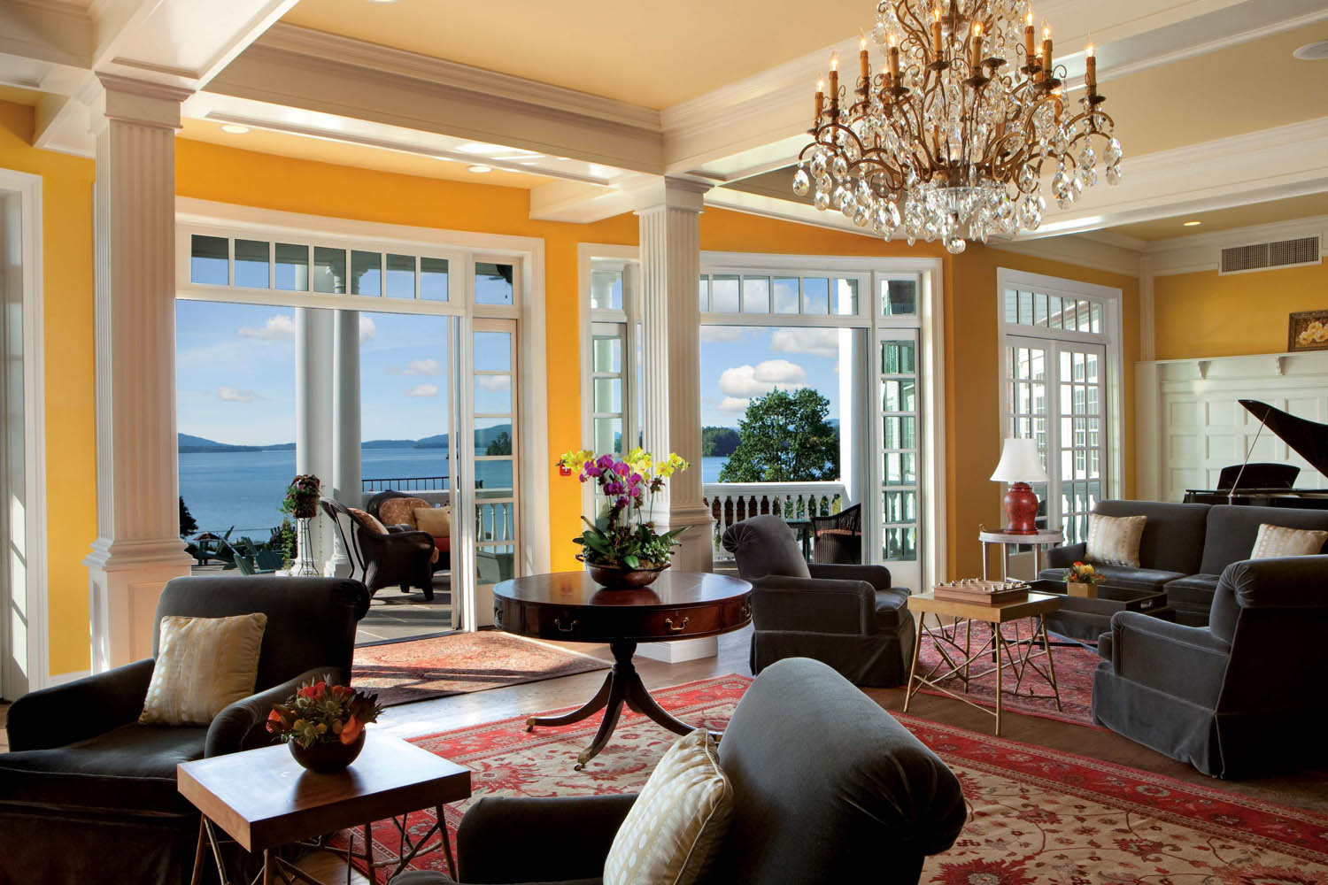 a living room with a chandelier and chairs