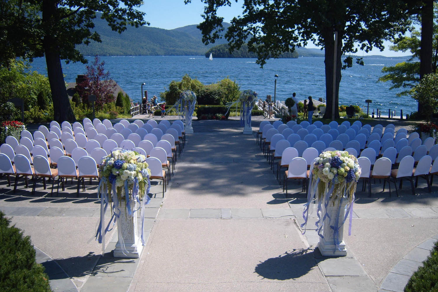 a wedding ceremony with chairs and flowers