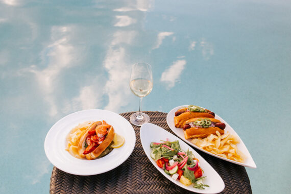 a plate of food and a glass of wine