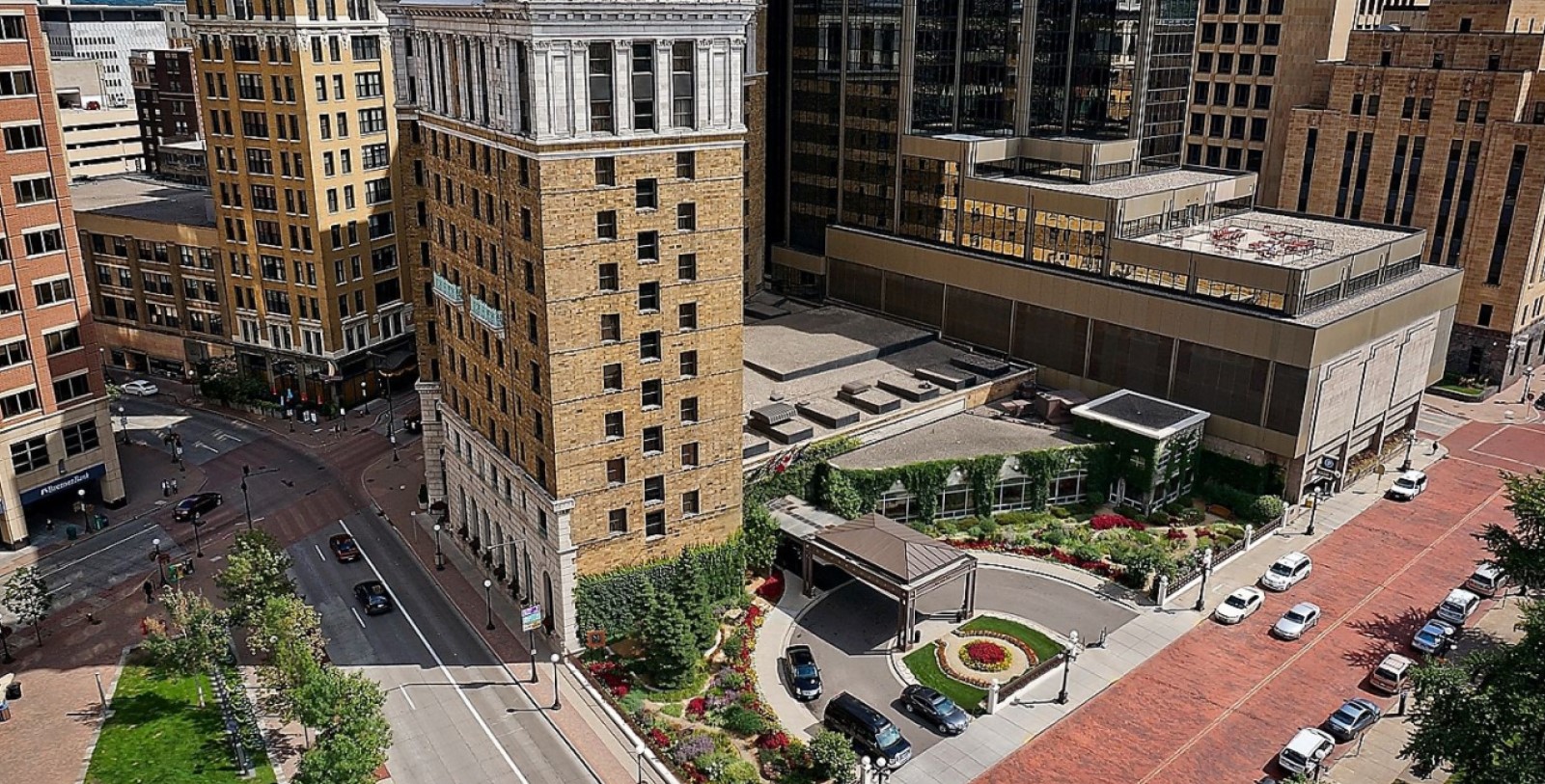 a building with a parking lot and cars parked on the side
