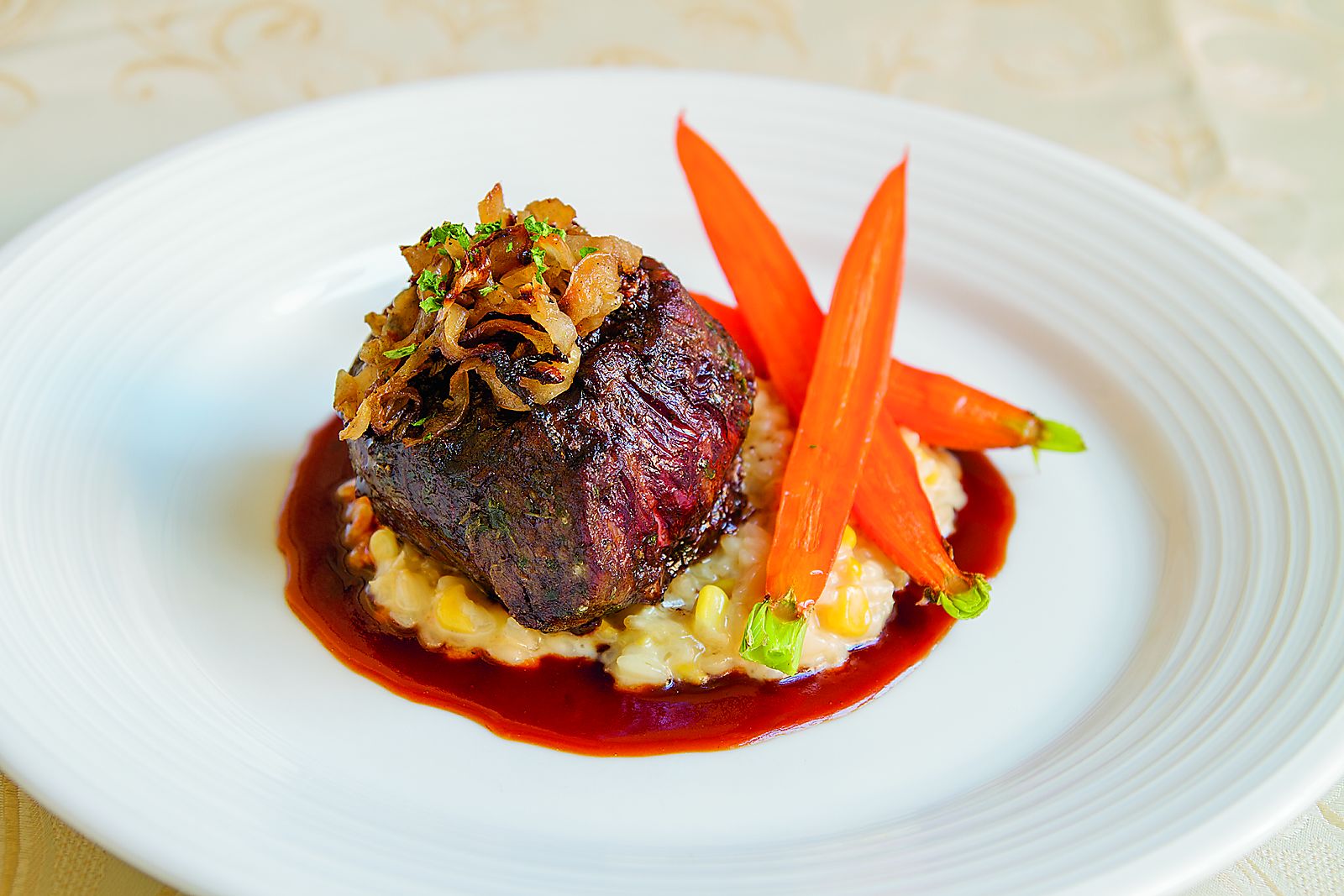 a plate of food with carrots and sauce