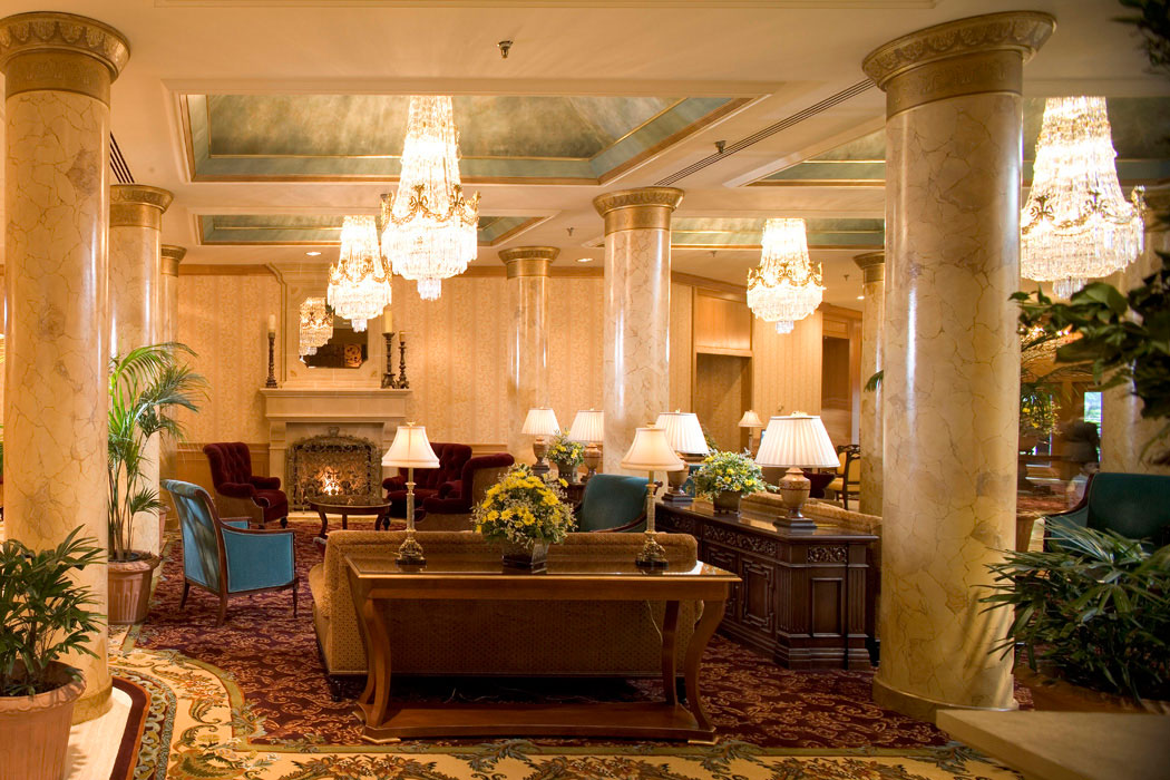 a room with a fireplace and chandeliers