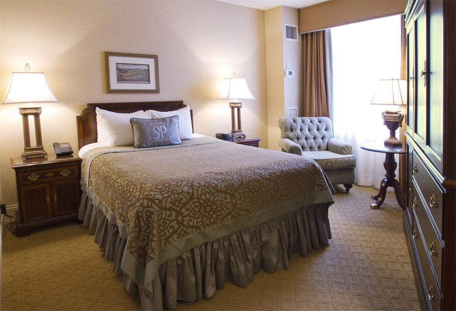 a bedroom with a bed and a chair