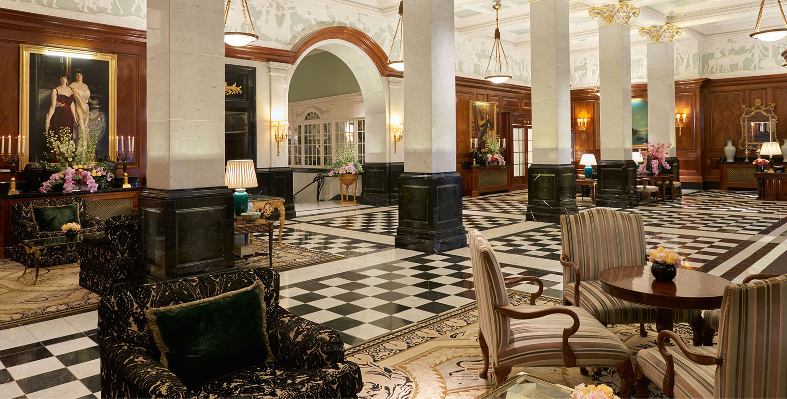 a large room with black and white checkered flooring and chairs