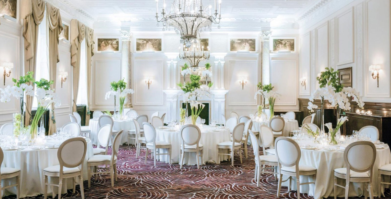 a room with white tables and chairs