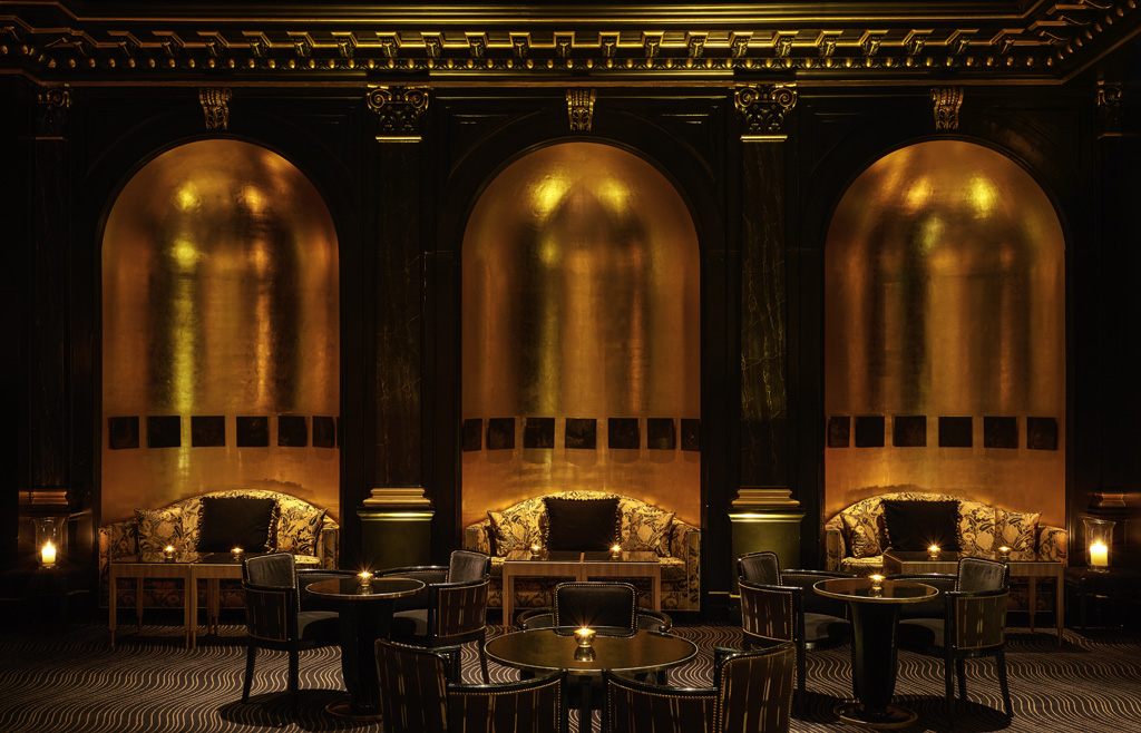 a room with gold walls and tables and chairs