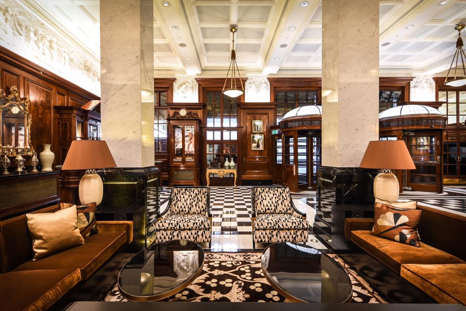 a room with a black and white checkered floor and a black and white patterned rug