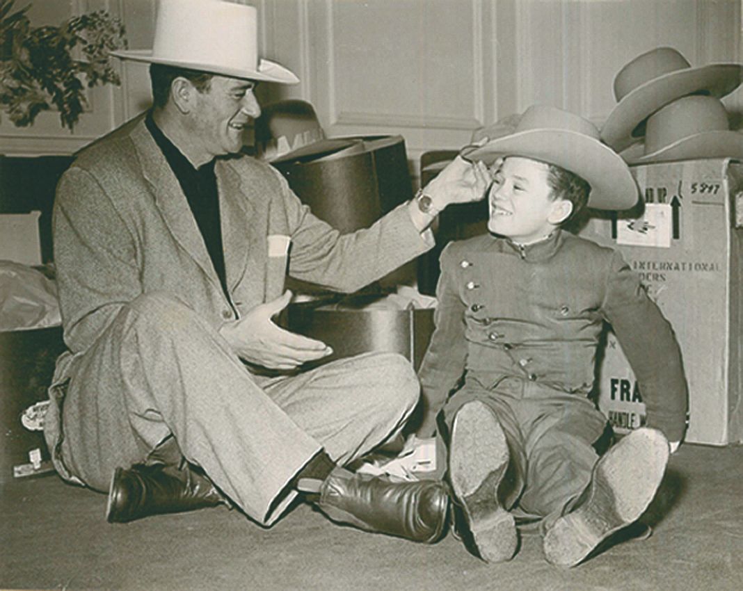 a man and boy wearing cowboy hats