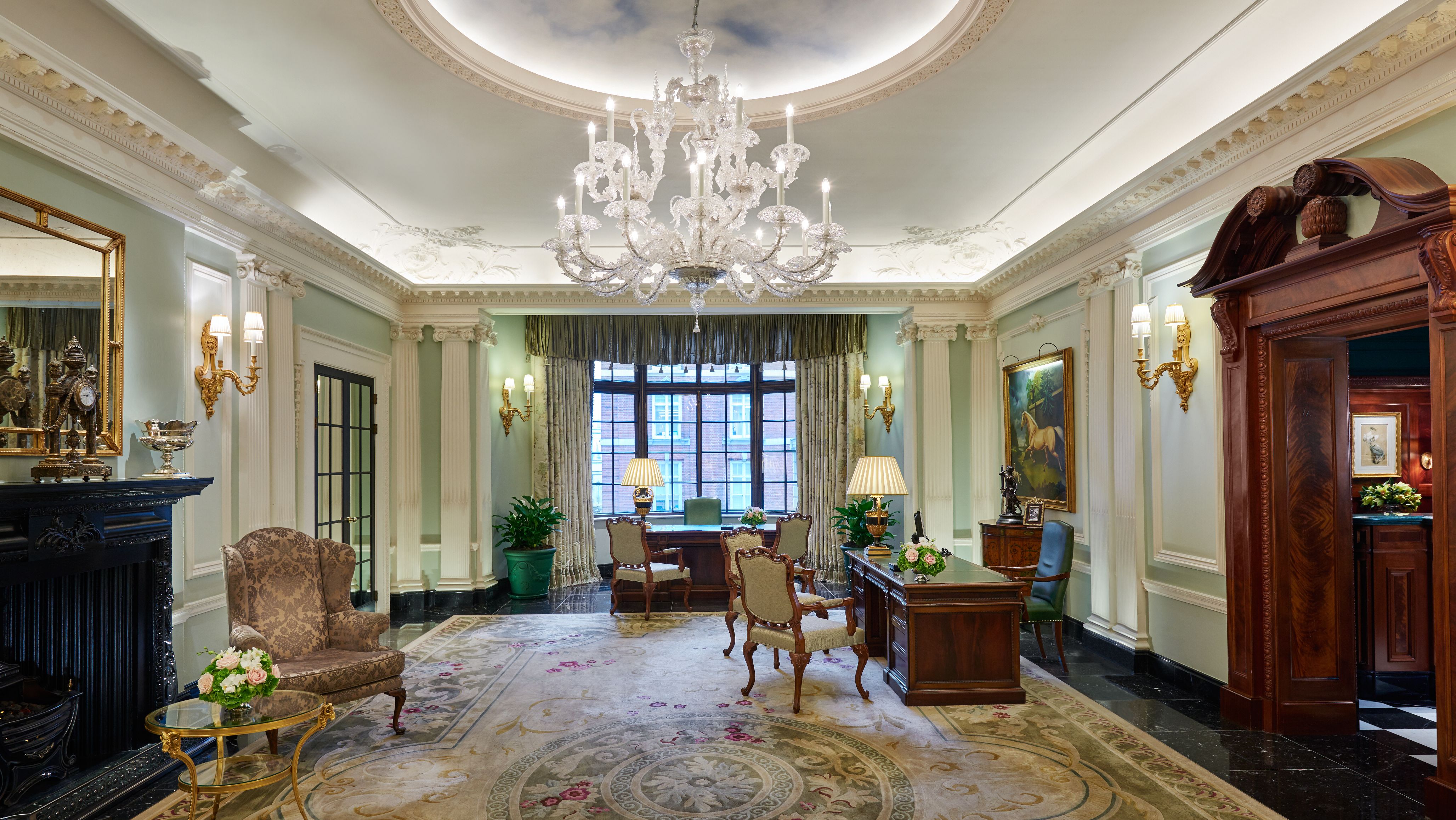 a room with a chandelier and chairs