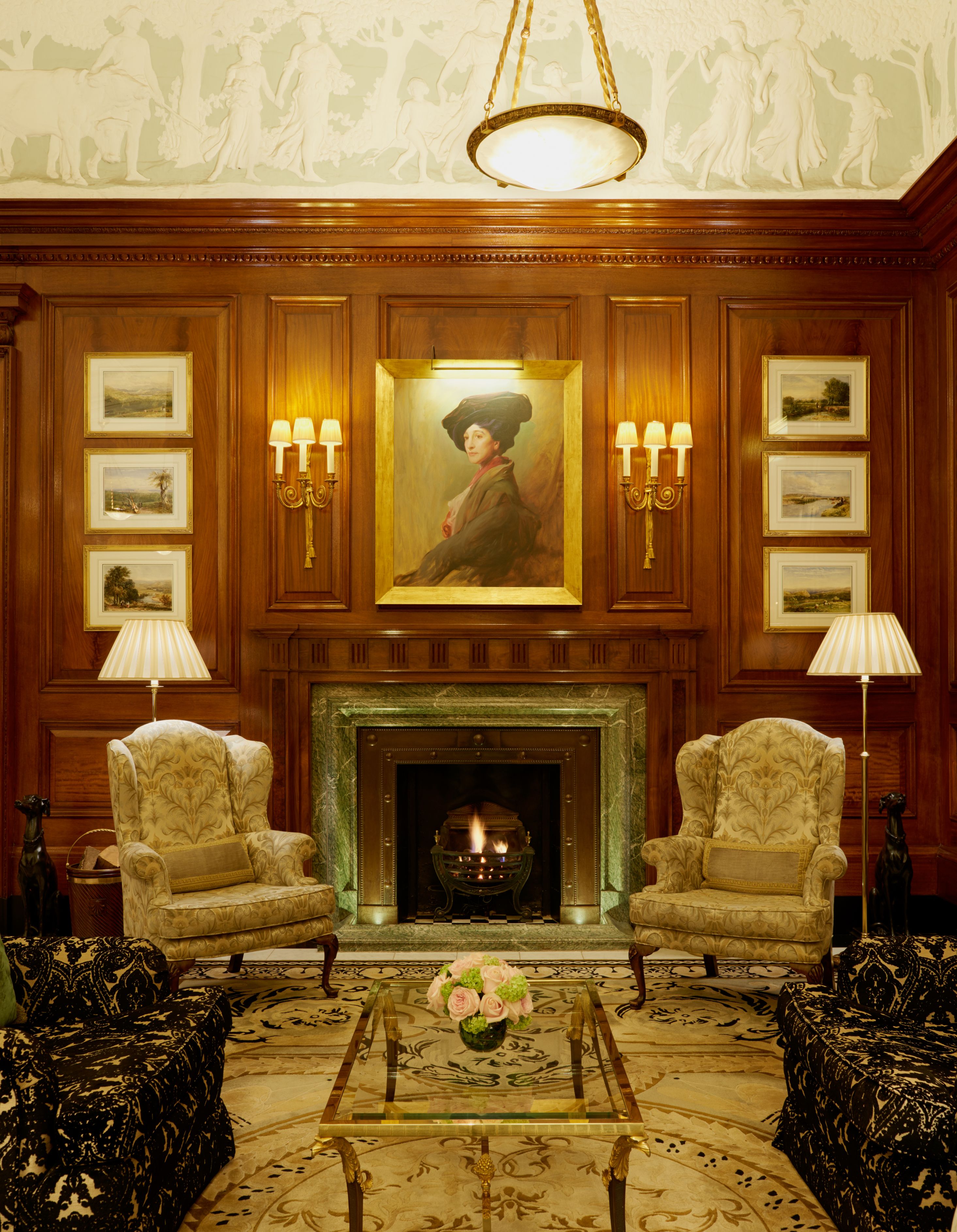 a room with a fireplace and chairs
