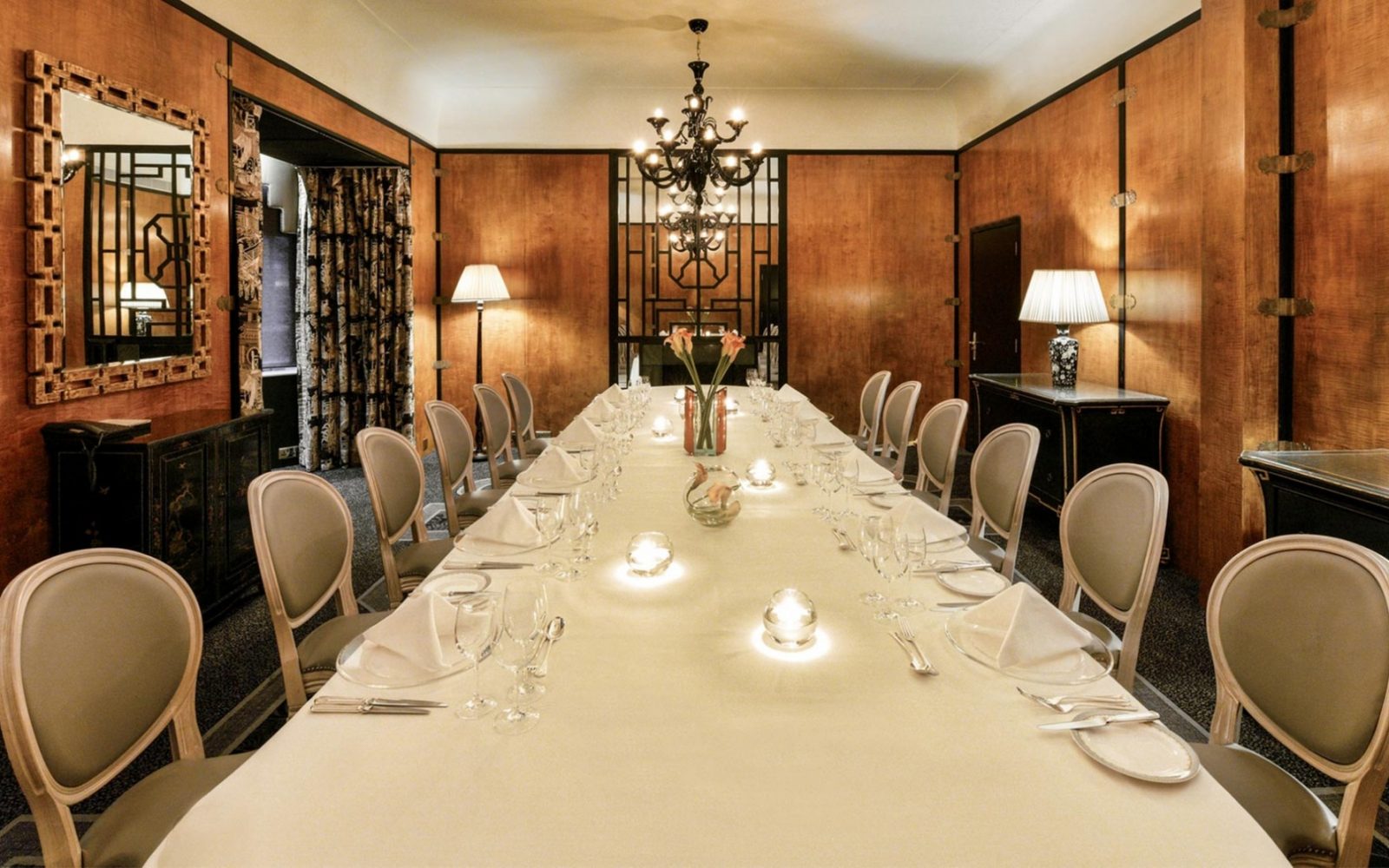 a long table with white cloths and silverware