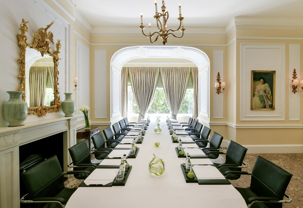 a room with a long table and chairs