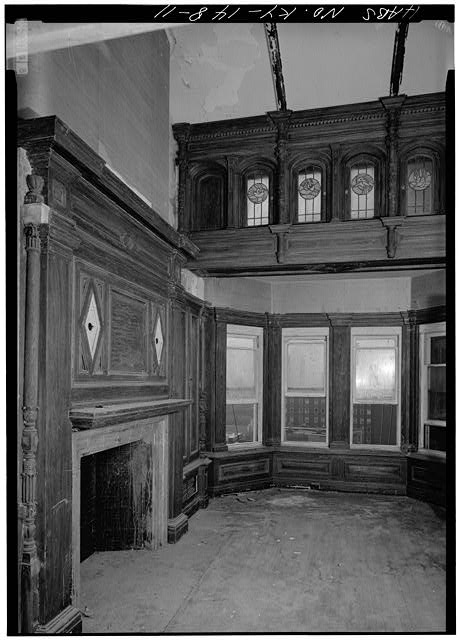 a room with wood paneling and windows