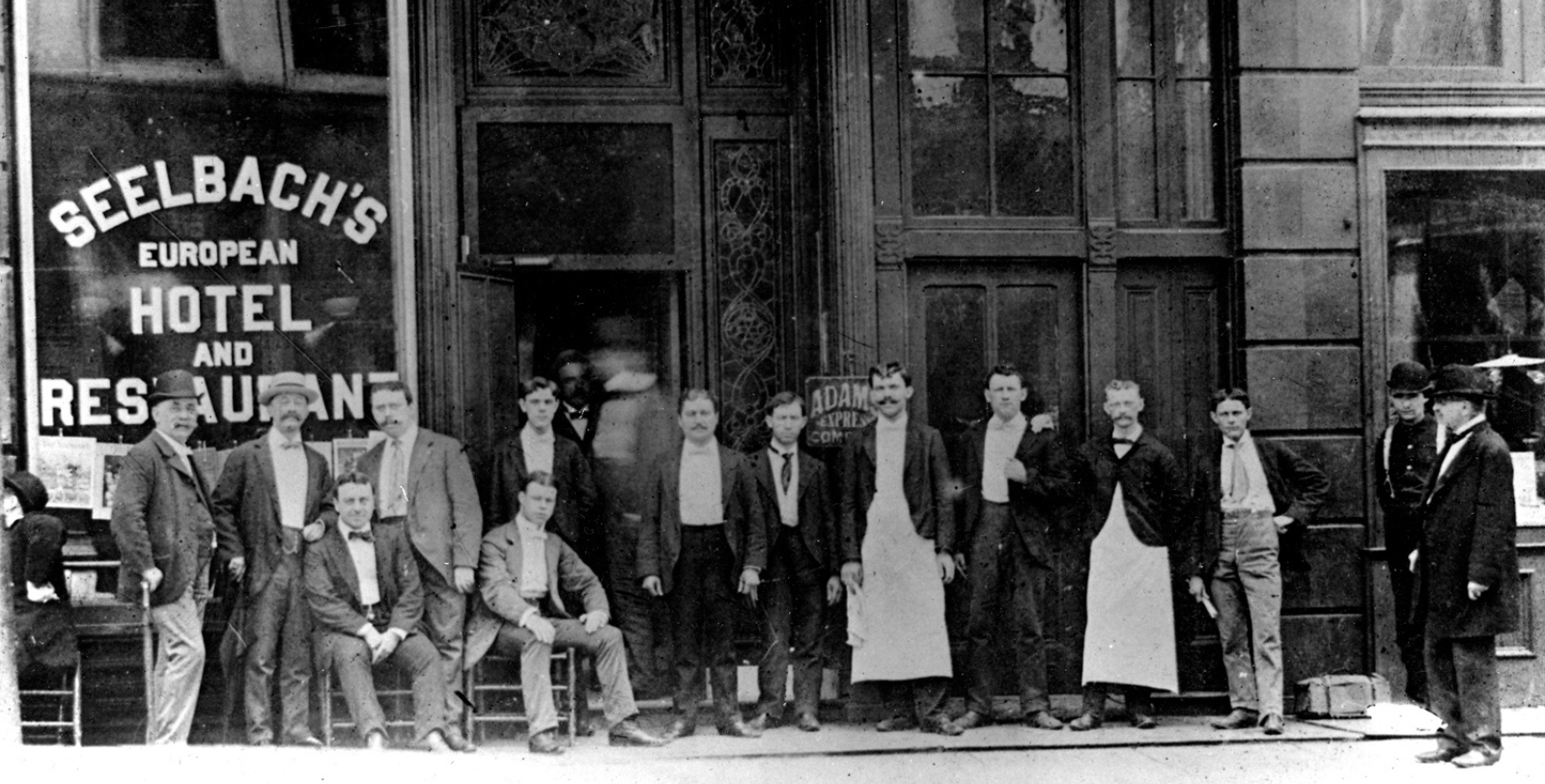 a group of men standing outside a building