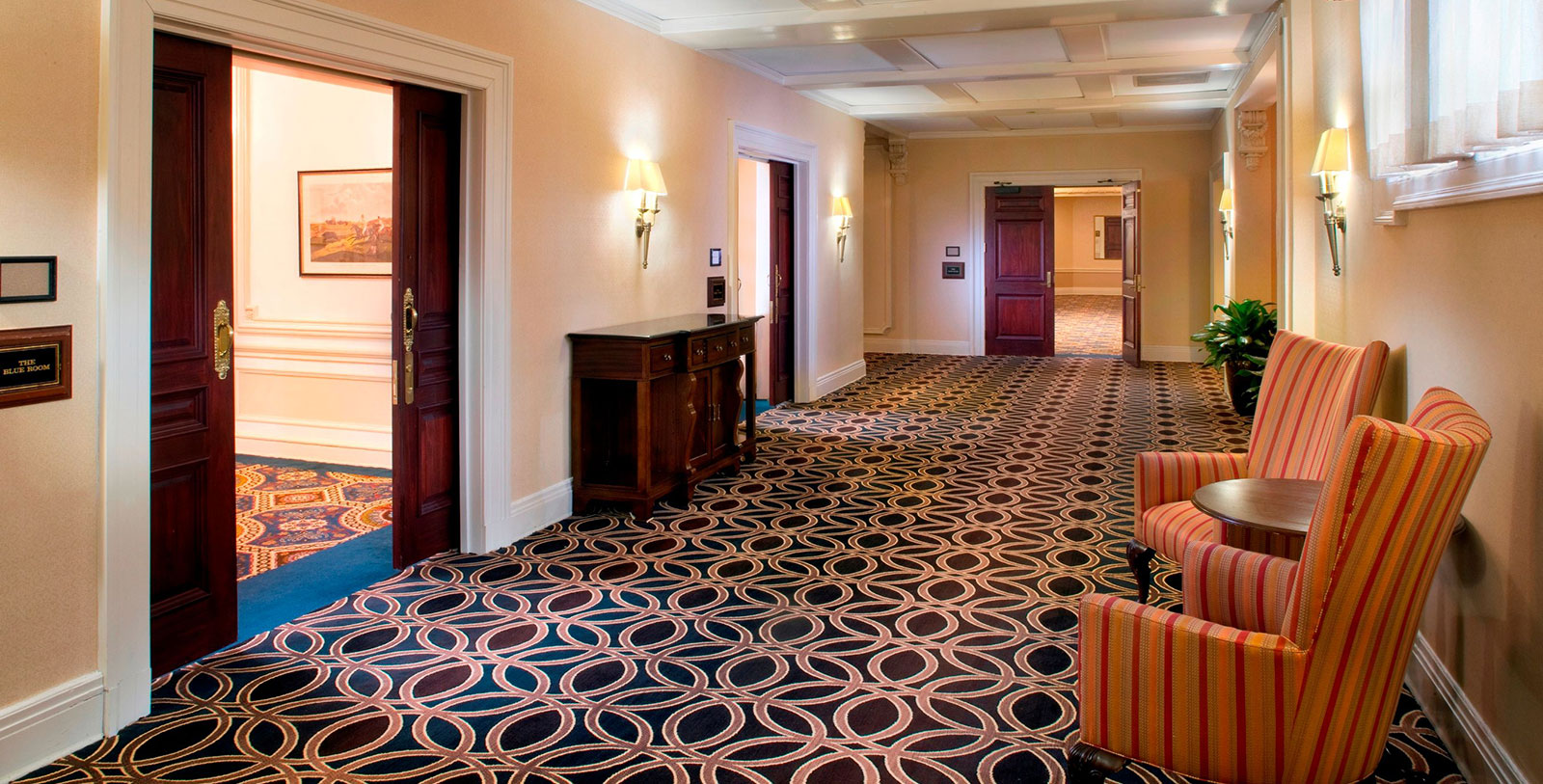 a hallway with chairs and a table