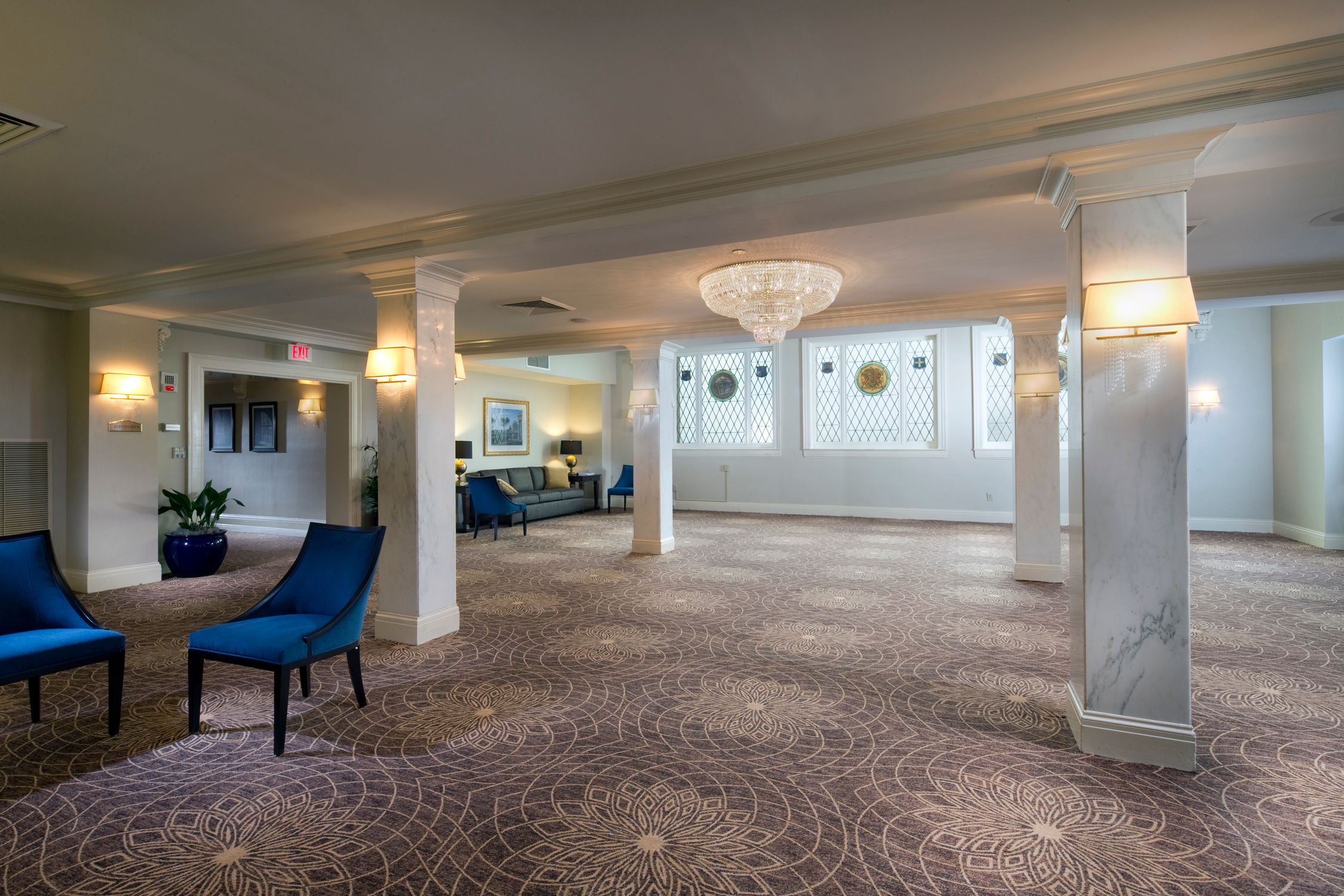 a room with columns and blue chair