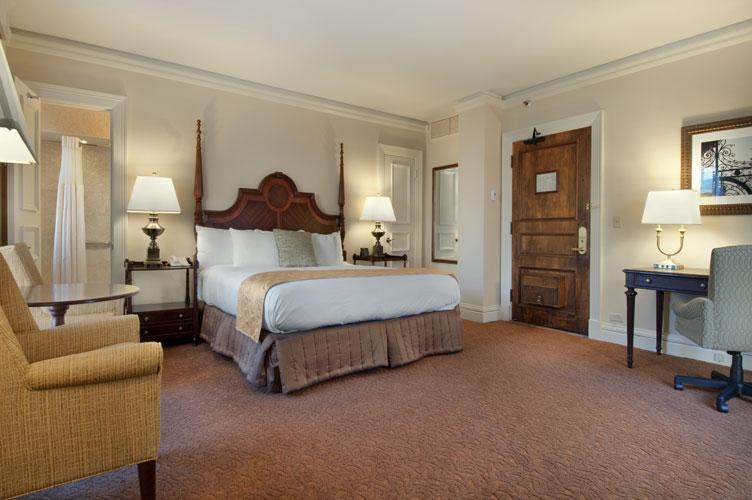 a bedroom with a bed and a chair