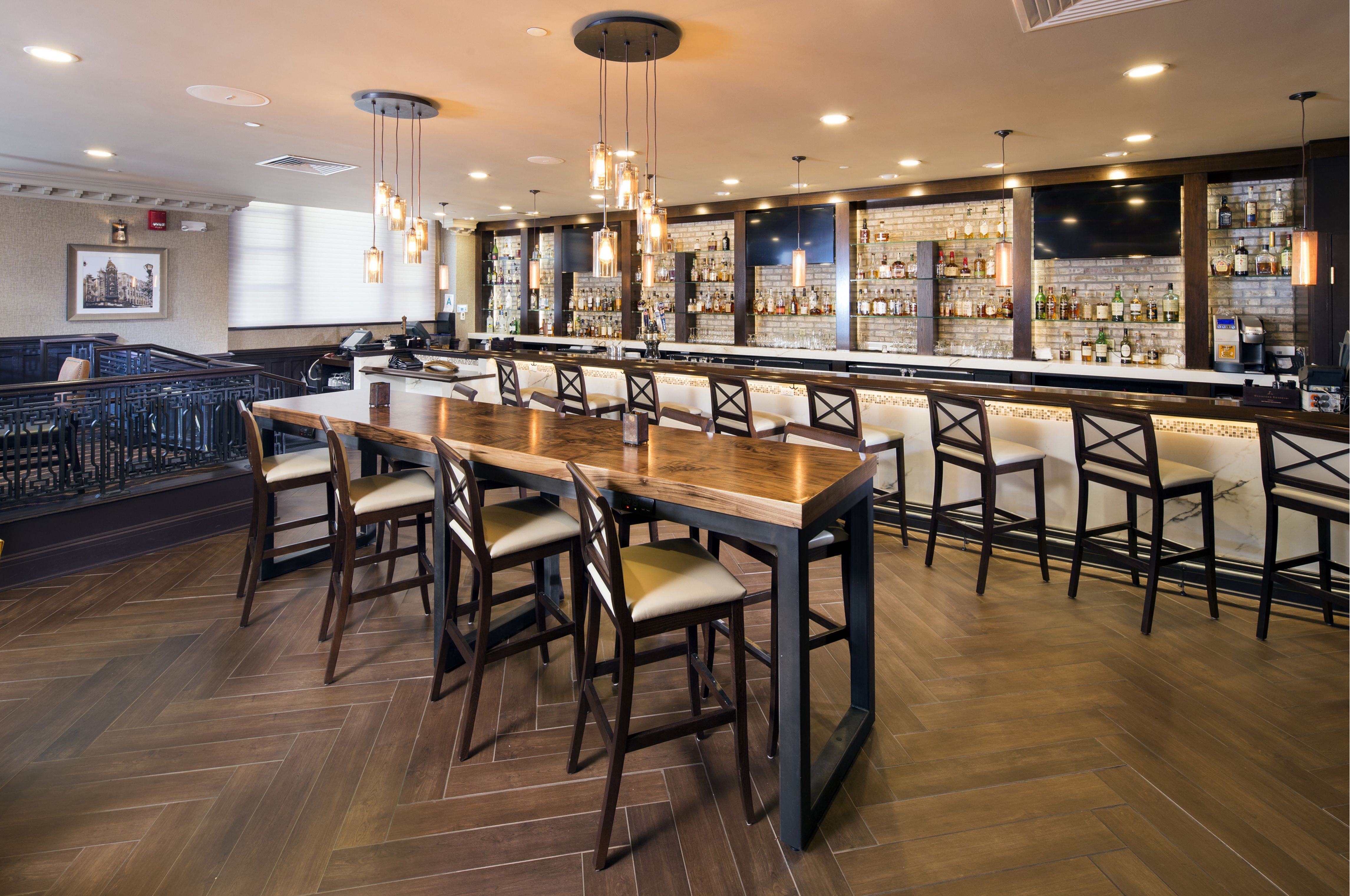 a bar with a long table and chairs
