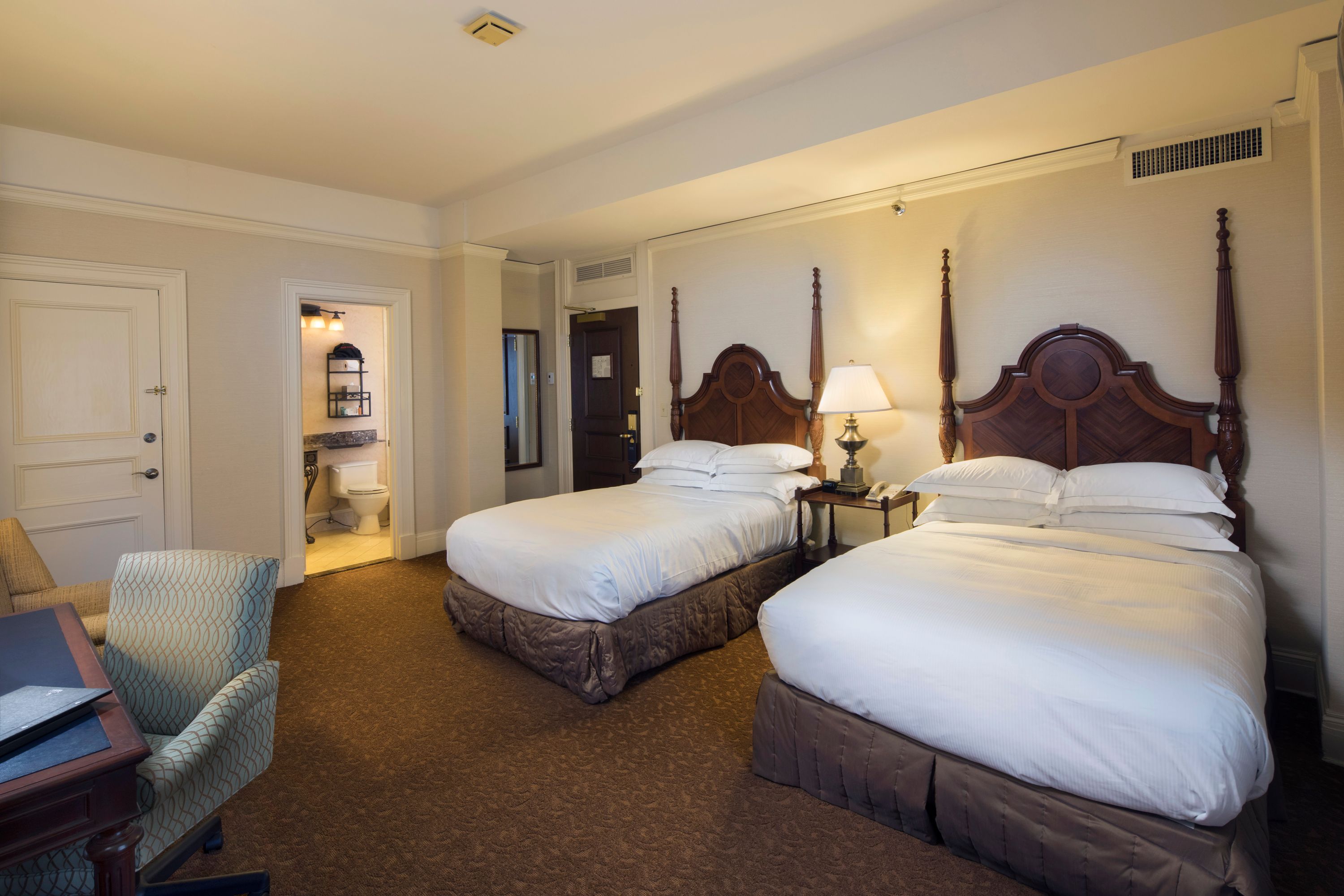 a room with two beds and a bed and a chair