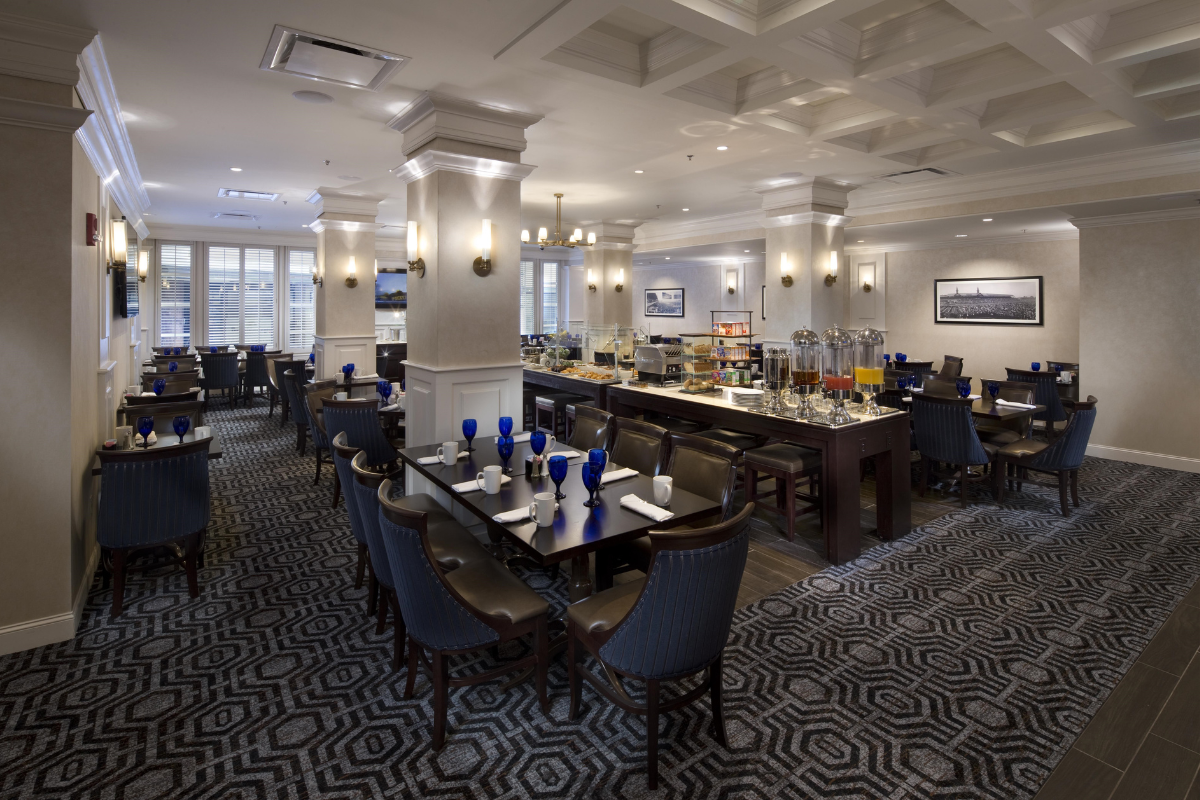 a room with a buffet table and chairs