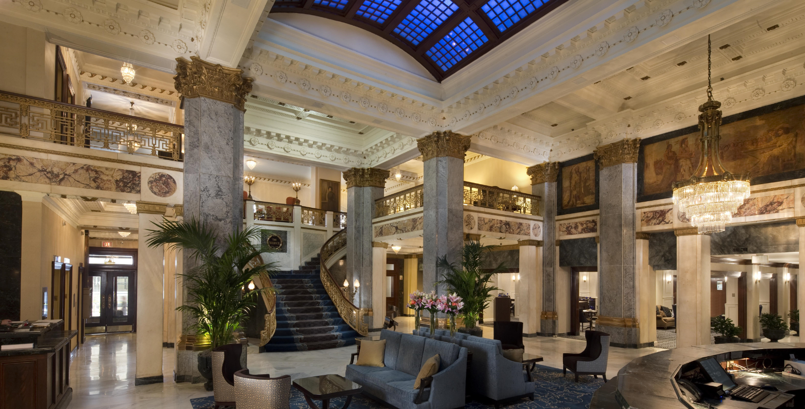 a large lobby with a staircase and a couch