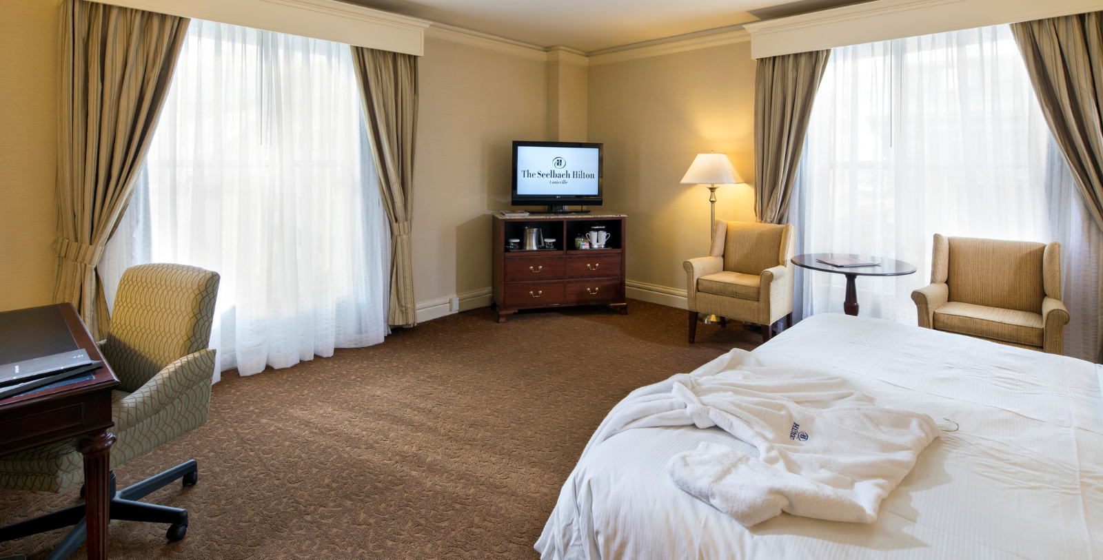 a room with a bed and a television