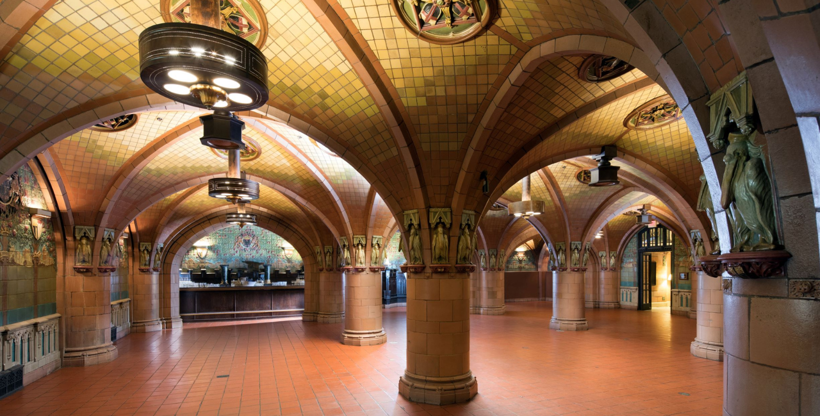 a large room with columns and tile walls