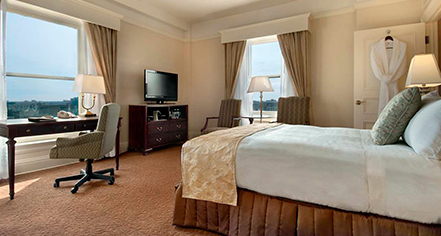 a room with a bed and a television