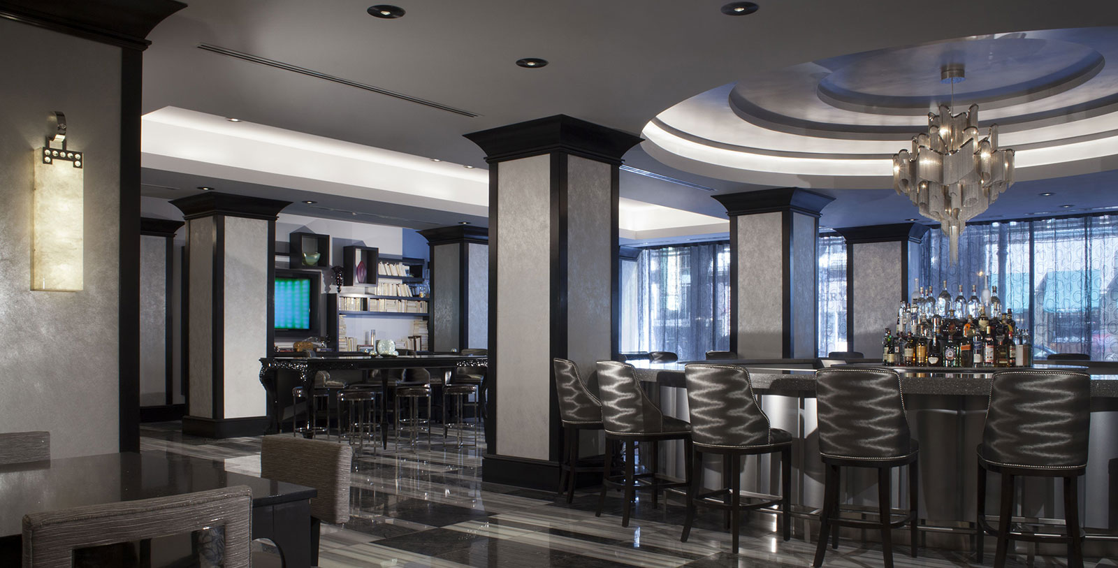 a room with a bar and chairs