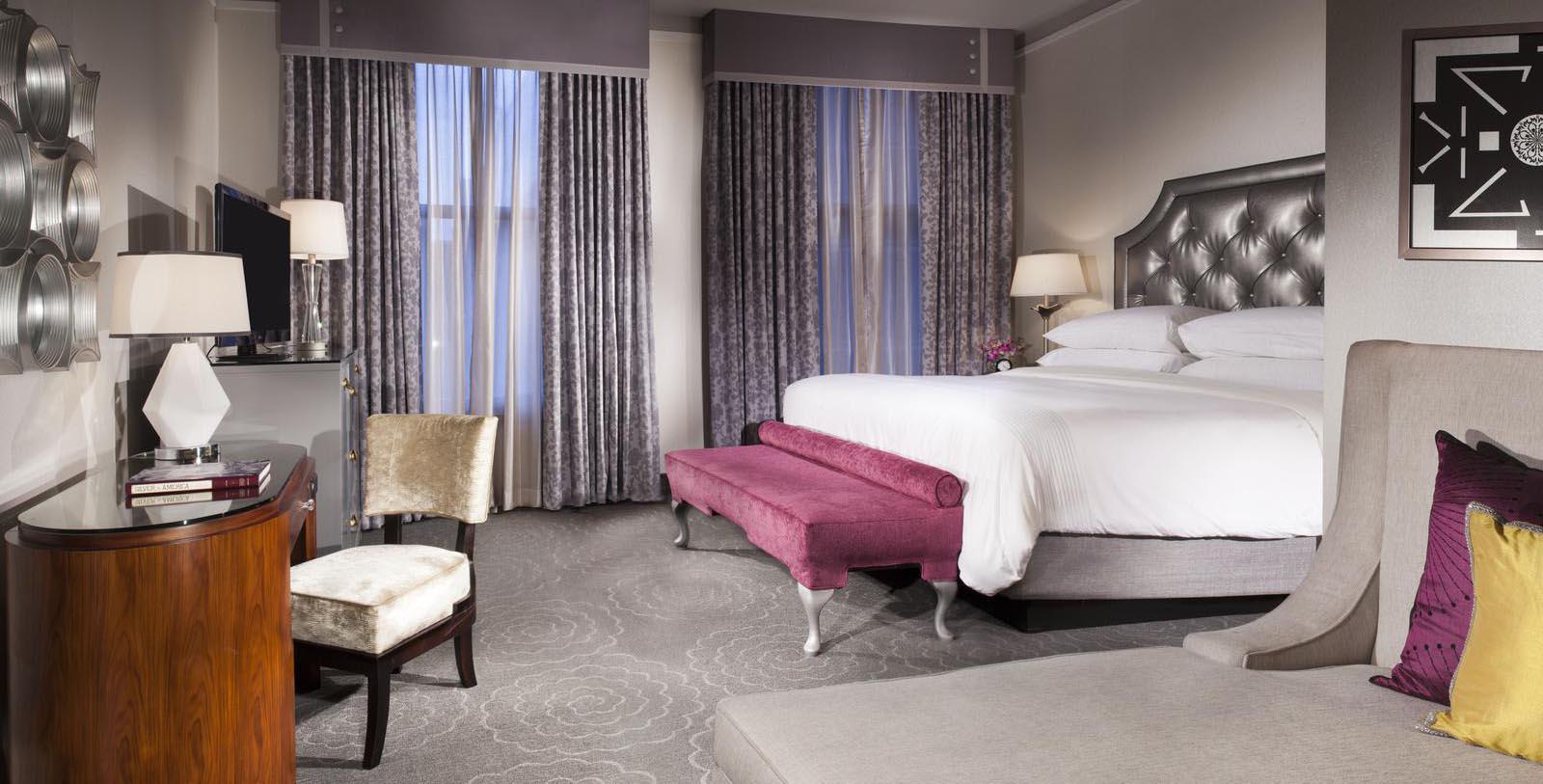 a bedroom with a bed and a bench