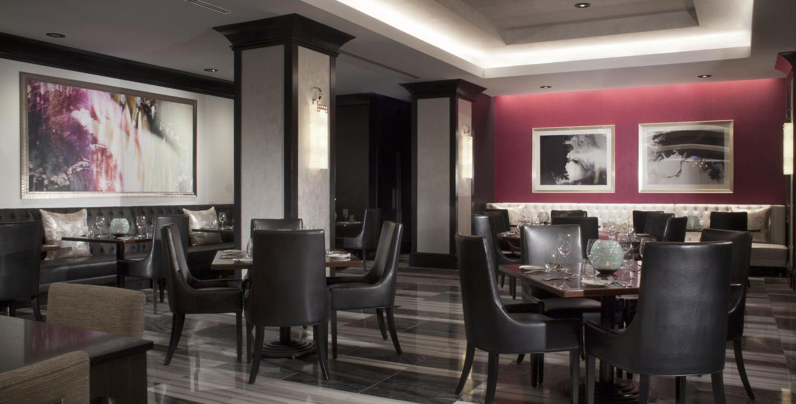 a restaurant with black chairs and tables
