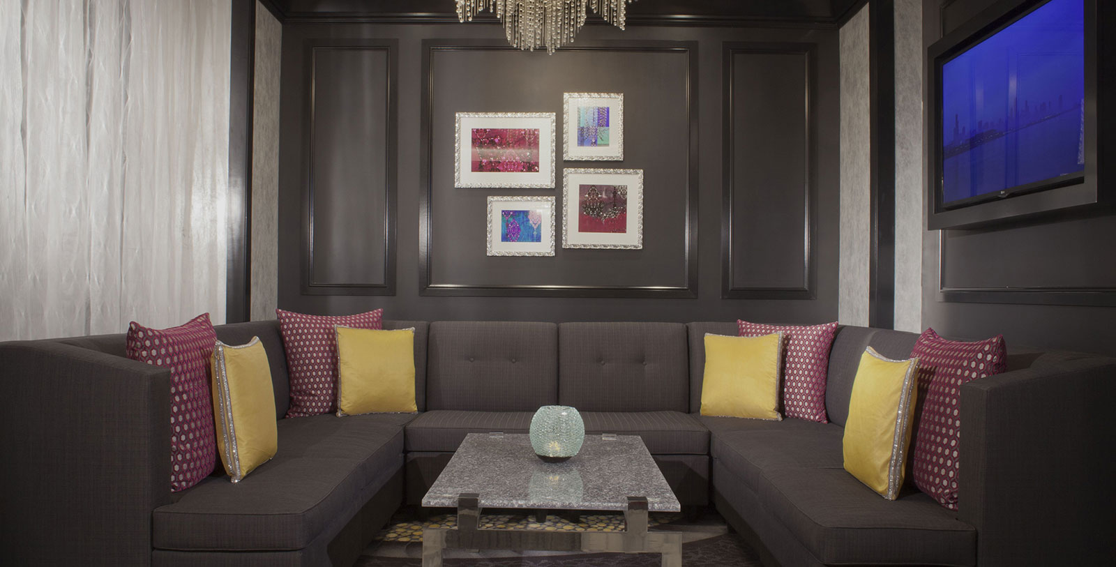 a living room with a couch and a chandelier