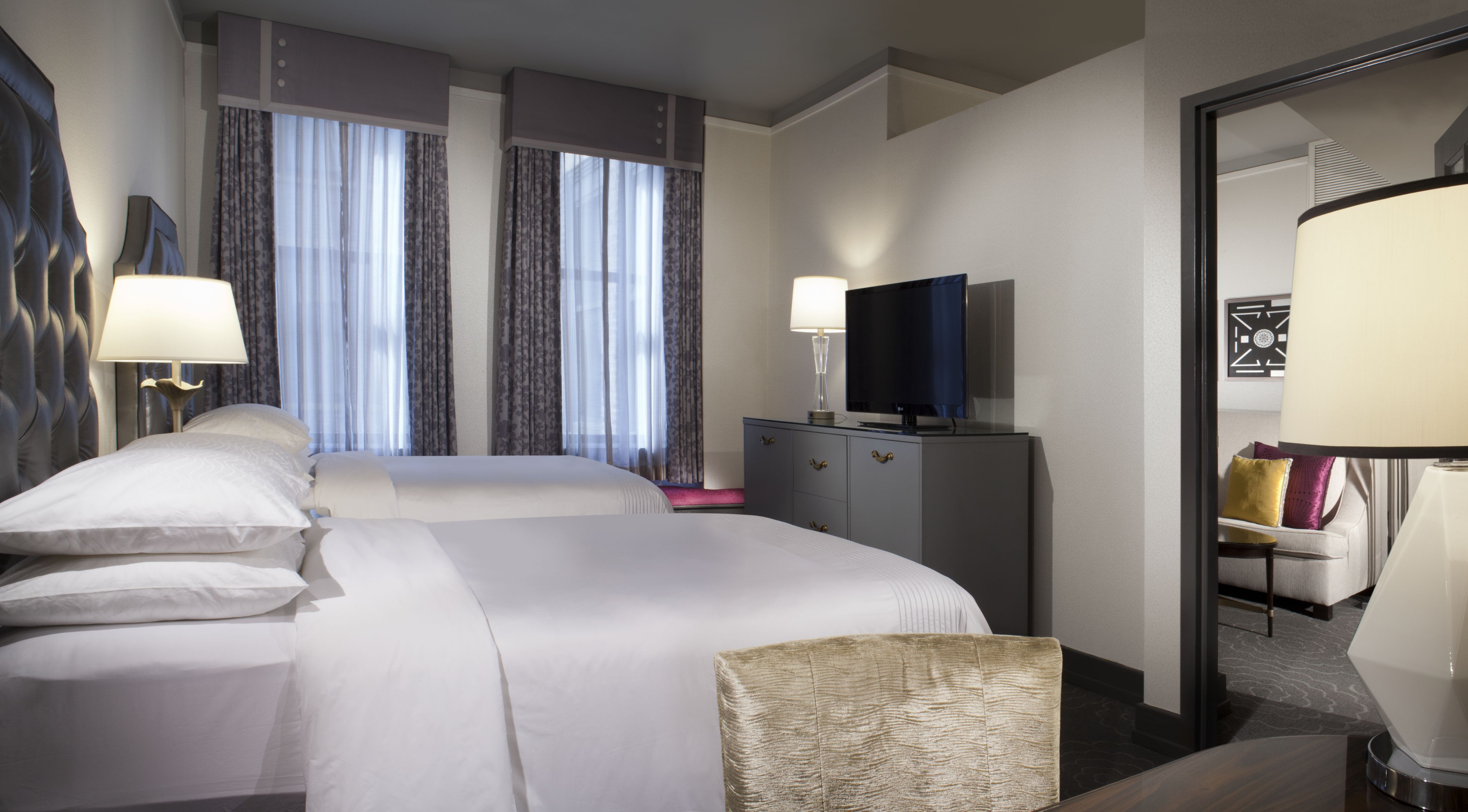 a room with two beds and a tv