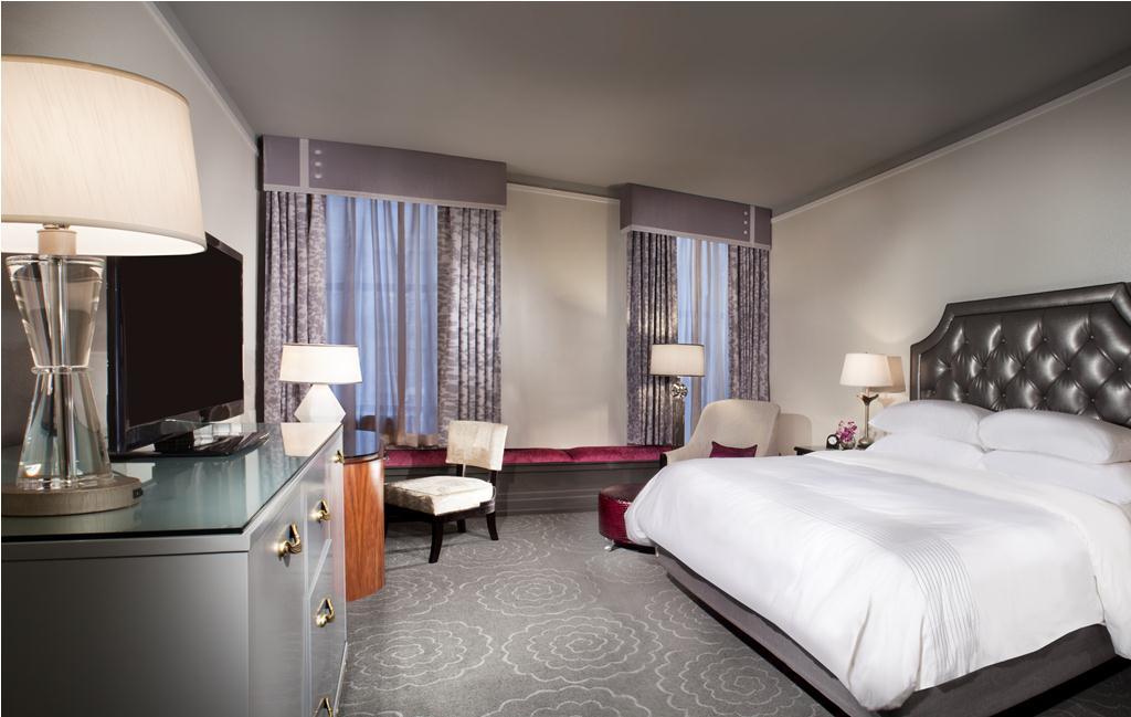 a room with a bed and a television